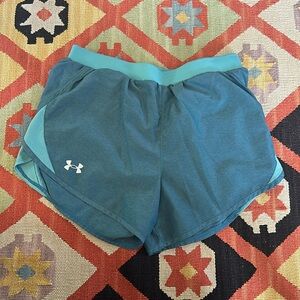 Small Blue Under Armour athletic shorts. Drawstring waist and attached lining.